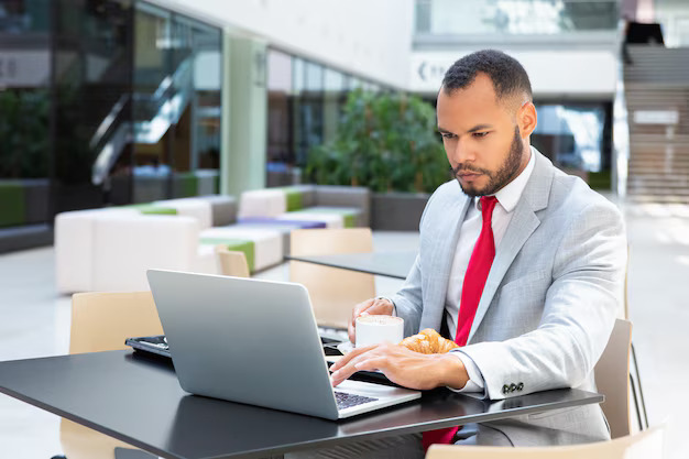 Ejecutivo Legalpin revisa su portatil en un cafe